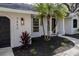 White house with dark garage door and landscaping at 7492 Deer Crossing Ct, Sarasota, FL 34240