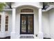 Elegant front entry with black double doors at 7492 Deer Crossing Ct, Sarasota, FL 34240