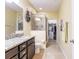 Bathroom showcasing a granite vanity, framed glass shower, and a walk-in closet at 8256 Enclave Way # 101, Sarasota, FL 34243