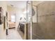 Bright bathroom features dual sinks, a granite vanity, and a glass framed shower with tile surround at 8256 Enclave Way # 101, Sarasota, FL 34243