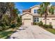 Tan three-story townhome with two-car garage at 8256 Enclave Way # 101, Sarasota, FL 34243