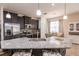 Stylish kitchen with granite countertops, stainless steel appliances, and barstool seating overlooking the dining area at 8256 Enclave Way # 101, Sarasota, FL 34243