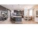 Open kitchen with an island, granite countertops, stainless steel appliances, and eat-in dining area at 8256 Enclave Way # 101, Sarasota, FL 34243