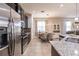 Modern kitchen with granite counters, stainless appliances, and adjacent dining area bathed in natural light at 8256 Enclave Way # 101, Sarasota, FL 34243