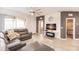 Living room with a large sectional sofa, decorative wall clock, and access to a screened patio at 8256 Enclave Way # 101, Sarasota, FL 34243