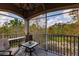 Relaxing screened-in patio with seating, offering beautiful views of the surrounding nature and landscape at 8256 Enclave Way # 101, Sarasota, FL 34243