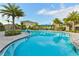 Community pool with inviting lounge area, surrounded by lush landscaping, and a refreshing escape at 8256 Enclave Way # 101, Sarasota, FL 34243
