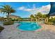 Sparkling community pool surrounded by palm trees, offering a refreshing escape and inviting relaxation at 8256 Enclave Way # 101, Sarasota, FL 34243