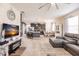 Open concept living area with sectional sofa, kitchen, and fireplace at 8256 Enclave Way # 101, Sarasota, FL 34243