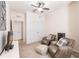 Spacious bedroom with two armchairs and double doors leading to another room at 8256 Enclave Way # 101, Sarasota, FL 34243