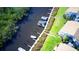 Aerial view of boat docks and waterway access with adjacent condominiums and green space at 8706 54Th W Ave # 18, Bradenton, FL 34210