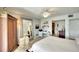 Bright bedroom with a ceiling fan, large mirror, and an ensuite bathroom at 8706 54Th W Ave # 18, Bradenton, FL 34210
