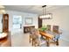 Charming dining area with modern light fixture is adjacent to an updated kitchen at 8706 54Th W Ave # 18, Bradenton, FL 34210