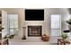 Cozy fireplace area with large windows for natural light and built in storage at 8706 54Th W Ave # 18, Bradenton, FL 34210