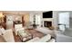 Open living room layout with a fireplace, TV, and dining area in neutral tones at 8706 54Th W Ave # 18, Bradenton, FL 34210