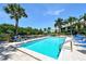 Inviting community pool with lounge chairs and palm trees at 8706 54Th W Ave # 18, Bradenton, FL 34210