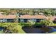 Beautiful condo building overlooking a pond and well-manicured green space, offering serene views and a peaceful atmosphere at 1211 Capri Isles Blvd # 26, Venice, FL 34292