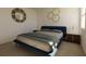 Bedroom with a blue bed frame and wood nightstands at 13028 Cedar Elm Lane, Parrish, FL 34219