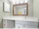 Bright bathroom with white vanity, large mirror, and updated fixtures at 1717 Pelican Cove Rd # 334, Sarasota, FL 34231