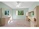 Bedroom with mirrored dresser, ceiling fan and carpet at 1717 Pelican Cove Rd # 334, Sarasota, FL 34231
