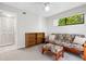 Versatile bedroom with a futon, ottoman, and built-in shelving at 1717 Pelican Cove Rd # 334, Sarasota, FL 34231