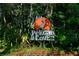 Pelican Cove community entrance sign with lush landscaping at 1717 Pelican Cove Rd # 334, Sarasota, FL 34231