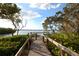 Wooden boardwalk leads to waterfront seating area at 1717 Pelican Cove Rd # 334, Sarasota, FL 34231