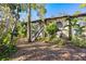 Exterior view of the condo building nestled among trees at 1717 Pelican Cove Rd # 334, Sarasota, FL 34231