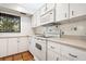 Kitchen with white cabinets, tile floors and a built-in microwave at 1717 Pelican Cove Rd # 334, Sarasota, FL 34231