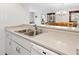 Kitchen with double sink, dishwasher, and view into dining area at 1717 Pelican Cove Rd # 334, Sarasota, FL 34231