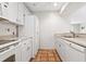 White kitchen with stainless steel appliances and tile floors at 1717 Pelican Cove Rd # 334, Sarasota, FL 34231
