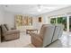 Relaxing living room with comfortable recliners and a view of the patio at 1717 Pelican Cove Rd # 334, Sarasota, FL 34231