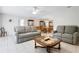 Spacious living room with comfortable seating and view to dining area at 1717 Pelican Cove Rd # 334, Sarasota, FL 34231