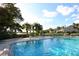 Community pool with waterfront views and seating at 1717 Pelican Cove Rd # 334, Sarasota, FL 34231