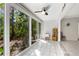 Bright sunroom with sliding glass doors leading to the backyard and tiled floor at 1717 Pelican Cove Rd # 334, Sarasota, FL 34231