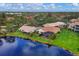 Aerial view showcasing a house's location near a tranquil lake at 220 Inlets Blvd, Nokomis, FL 34275