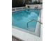 A clear swimming pool with concrete and white tile surround and a metal ladder at 33 S Gulfstream Ave # 307, Sarasota, FL 34236