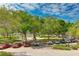 View of a park-like setting with cars parked near lush trees at 33 S Gulfstream Ave # 307, Sarasota, FL 34236