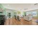 Bright living room with light wood floors, comfy seating, and large windows at 3712 Hampshire Ln # 5623, Sarasota, FL 34232