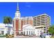 Church with steeple and modern buildings nearby at 3712 Hampshire Ln # 5623, Sarasota, FL 34232