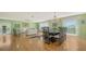 Elegant dining room with a modern table, chandelier, and hardwood floors at 3712 Hampshire Ln # 5623, Sarasota, FL 34232