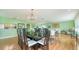 Open dining room with hardwood floors and a view into the living room at 3712 Hampshire Ln # 5623, Sarasota, FL 34232
