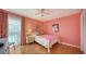 Cozy bedroom with light wood floors, and a pink color scheme at 3712 Hampshire Ln # 5623, Sarasota, FL 34232