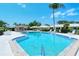 Community pool with a surrounding patio and lounge chairs at 3712 Hampshire Ln # 5623, Sarasota, FL 34232