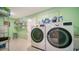 Laundry room with modern washer and dryer, and storage shelving at 3712 Hampshire Ln # 5623, Sarasota, FL 34232