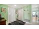 Entryway with light green walls, white closet doors, and a patterned rug at 3712 Hampshire Ln # 5623, Sarasota, FL 34232