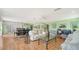 Open living and dining area with light wood floors and neutral decor at 3712 Hampshire Ln # 5623, Sarasota, FL 34232