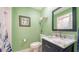 Clean bathroom with marble vanity and a light green color scheme at 3712 Hampshire Ln # 5623, Sarasota, FL 34232