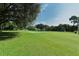 Green grass golf course with trees and sand traps at 3712 Hampshire Ln # 5623, Sarasota, FL 34232