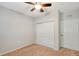 Bedroom with ceiling fan, mirrored closet doors, and neutral carpeting at 3956 Mediterranea Cir # 412, Sarasota, FL 34233